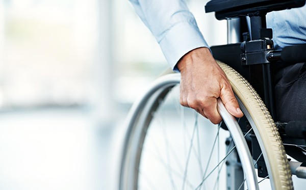 Closeup shot of an unrecognizable man sitting in a wheelchair